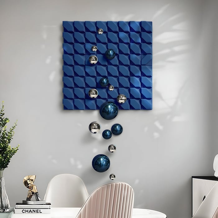 Blue 3D wall art with metallic orbs floating downward, displayed in a stylish white dining nook.