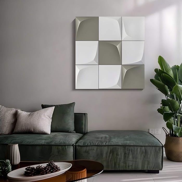 Modern seating area with soft green sofa and minimalist gray-and-white geometric wall tiles in a 3x3 layout.