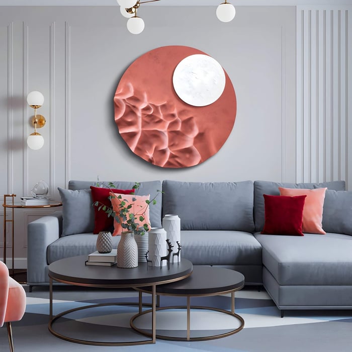 Round textured wall sculpture in copper and white above a pastel-toned sofa, blending luxury with abstract organic forms.