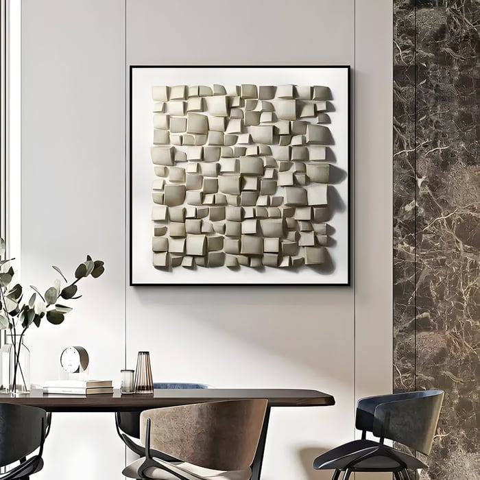 Sculptural dining room wall art with layered neutral blocks and folded forms for a modern textural look.