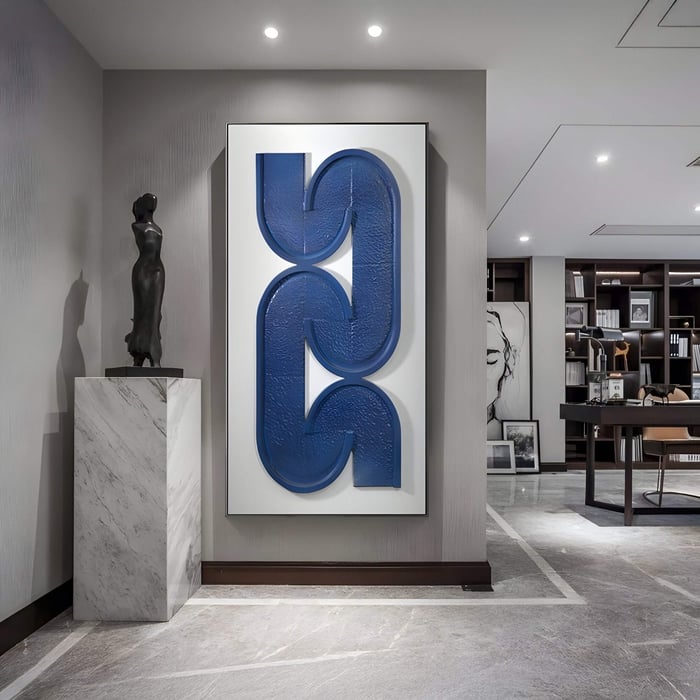 Modern hallway featuring a large vertical blue sculptural artwork resembling interlocking links, framed in white.