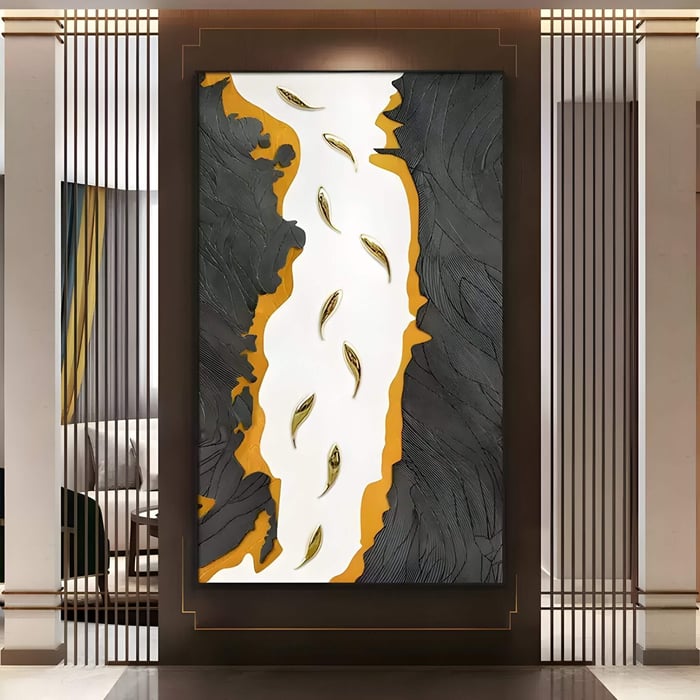 Large 3D wall panel with black, orange, and white textured design featuring golden leaf-like forms in a stylish entryway display.