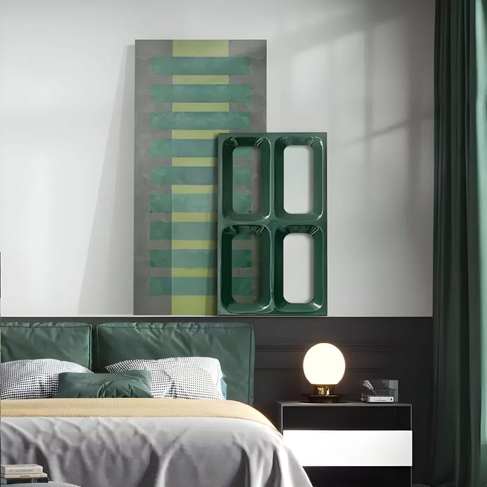 Green geometric wall art in a bedroom with matching decor, featuring bold shapes and layered vertical and horizontal designs.