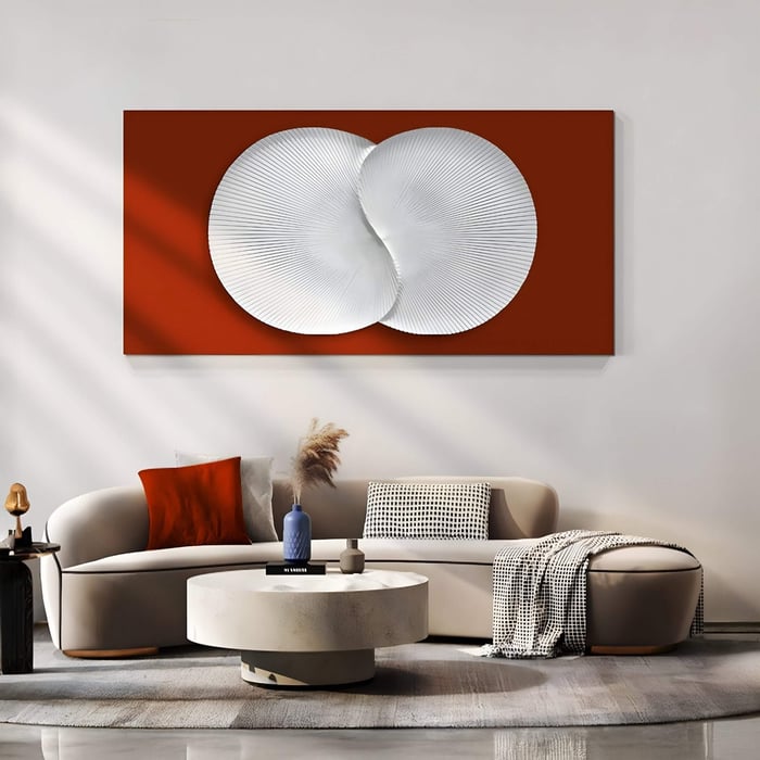 Large red wall panel with intersecting white circular 3D patterns above a modern beige sofa in a stylish living room setup.