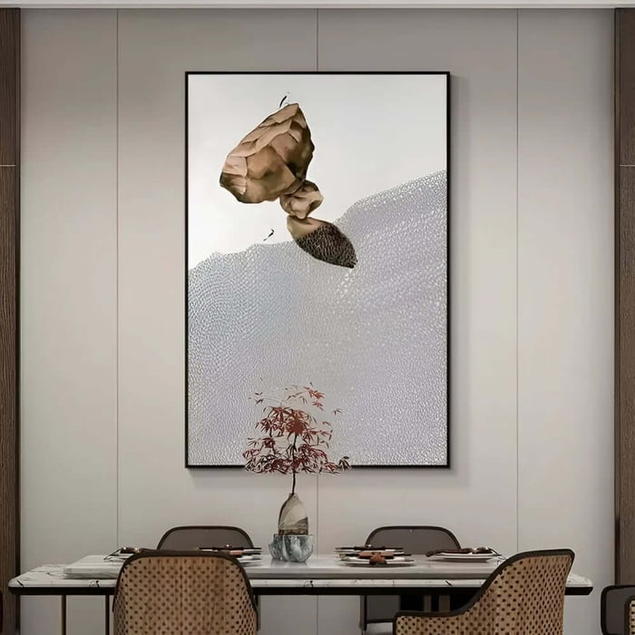 Minimalist Zen art with abstract floating rock and textured white background above a modern dining table.
