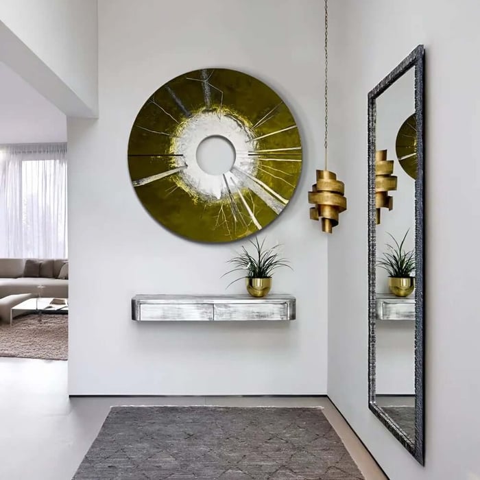 Round green and white abstract Zen wall art with central opening in a modern hallway entrance.