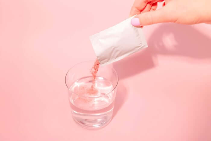 A person pouring a drink into a glass