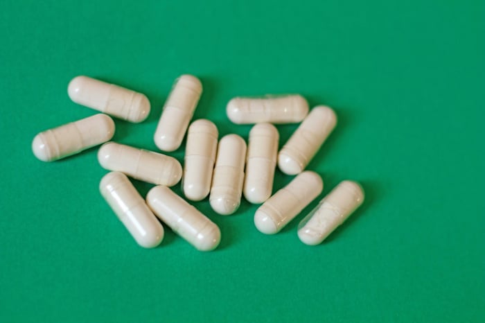 A pile of pills sitting on top of a green table