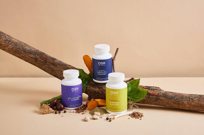 A group of bottles sitting on top of a wooden stick