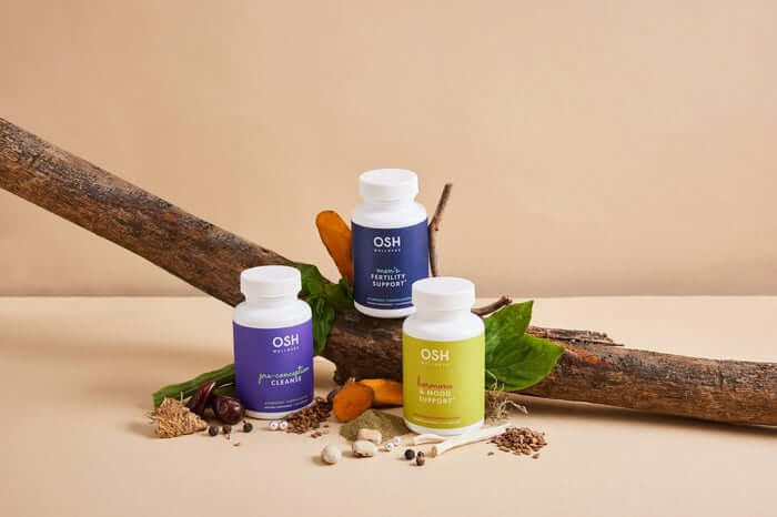 A group of bottles sitting on top of a wooden stick