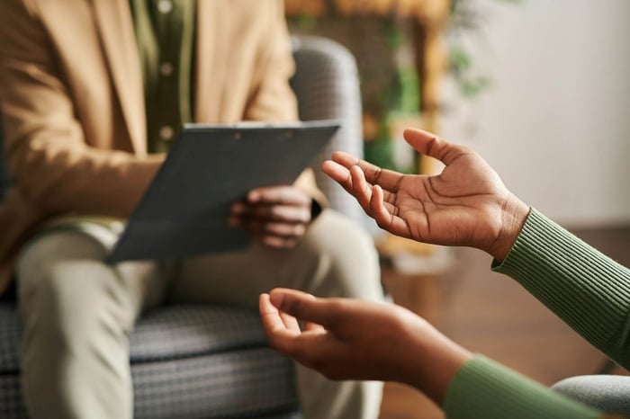 A therapist or healthcare professional talking with a patient