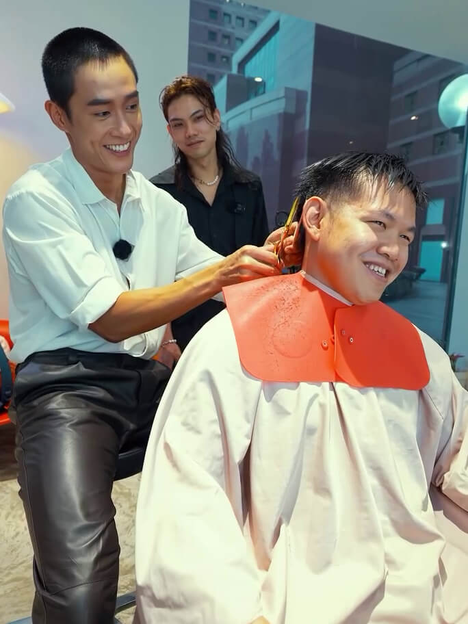 Shunji Matsuo Director, Lawrence, right by Tyler's side making sure the haircut went smoothly