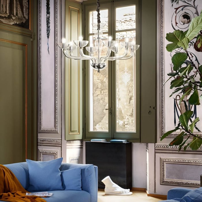 Contemporary glass chandelier with bowl-shaped lights in a colorful, artistic living space.