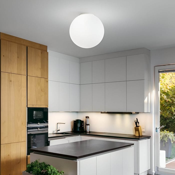 Kitchen ceiling light — Contemporary kitchen with white cabinets, wood accents, and a large globe flush-mount ceiling light.