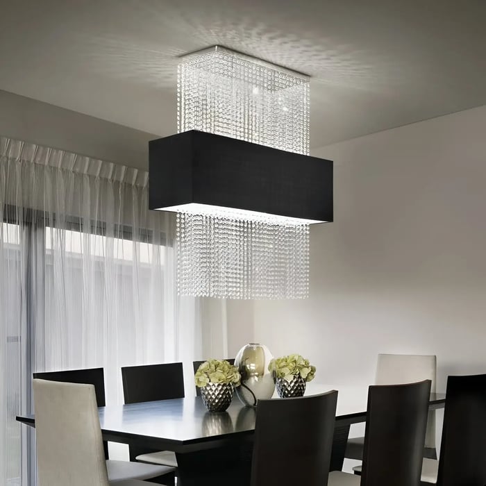 Contemporary dining room with a rectangular crystal chandelier, black table, and mixed beige and dark dining chairs.