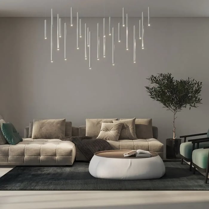 Cozy living room with modular beige sofas and suspended tube lights creating a minimalist glow.