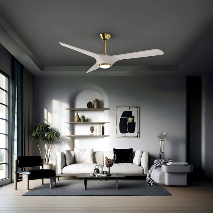 Sleek white ceiling fan with gold accents and built-in light above a bright modern sofa.