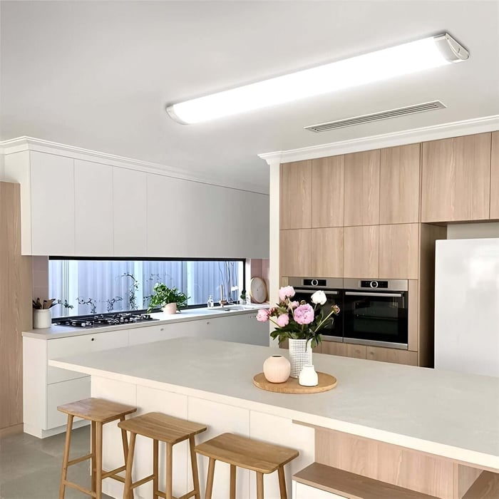 Batten Lights in a modern kitchen ceiling lighting an island and worktop area.