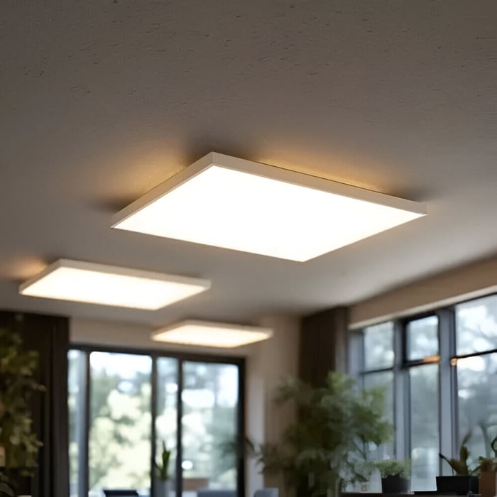 hree square surface-mounted LED panel lights installed in a bright room with large windows.