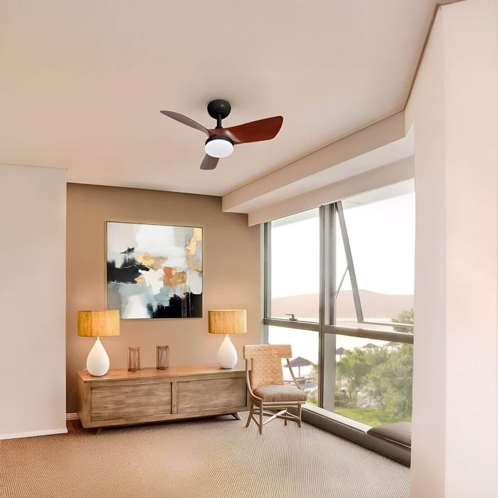 Compact ceiling fan with wooden blades and central light in a sunlit room.