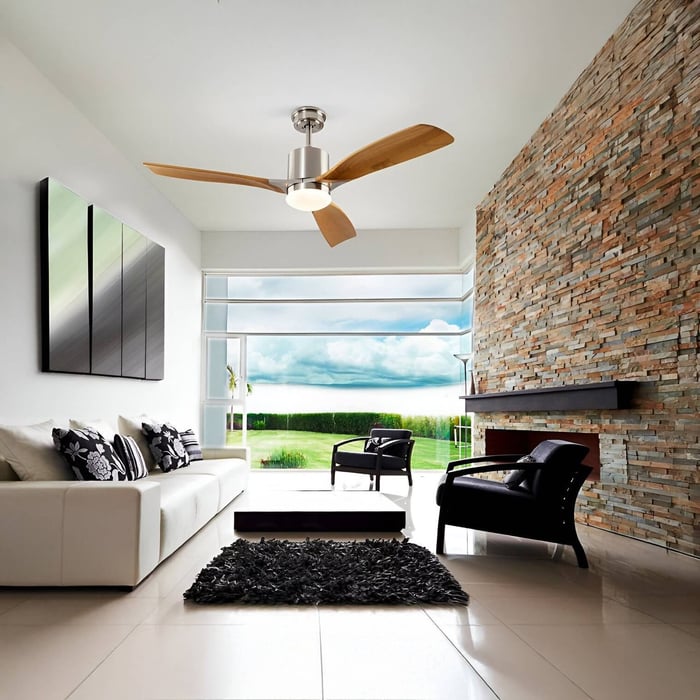 Ceiling fan with wooden blades and central light in a stone-accent modern lounge.