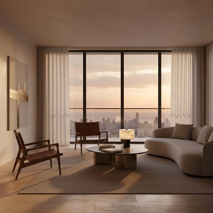 Minimalist living room at sunset with expansive floor-to-ceiling windows and city skyline views, featuring a low round coffee table with a softly glowing layered table lamp.