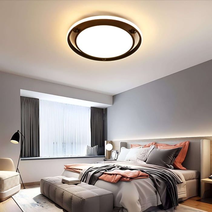Modern bedroom with warm round flush ceiling light and layered bedside lighting.