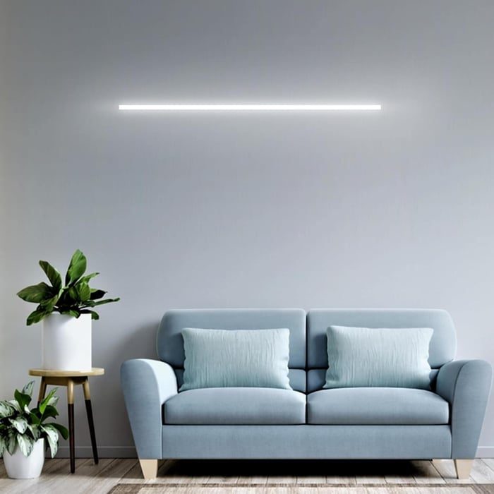 Batten Lights mounted on a wall above a sofa in a minimalist living room.