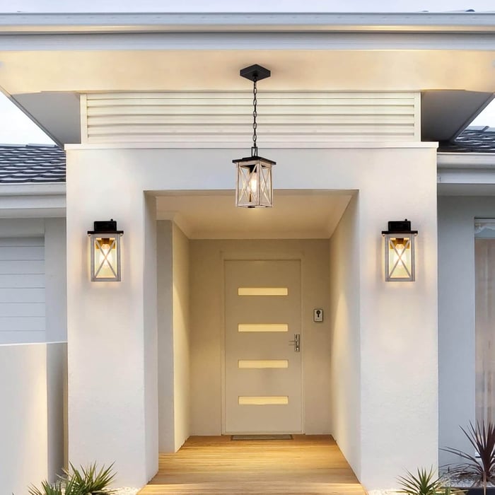Front porch entryway with a hanging lantern pendant light and two matching wall lanterns.