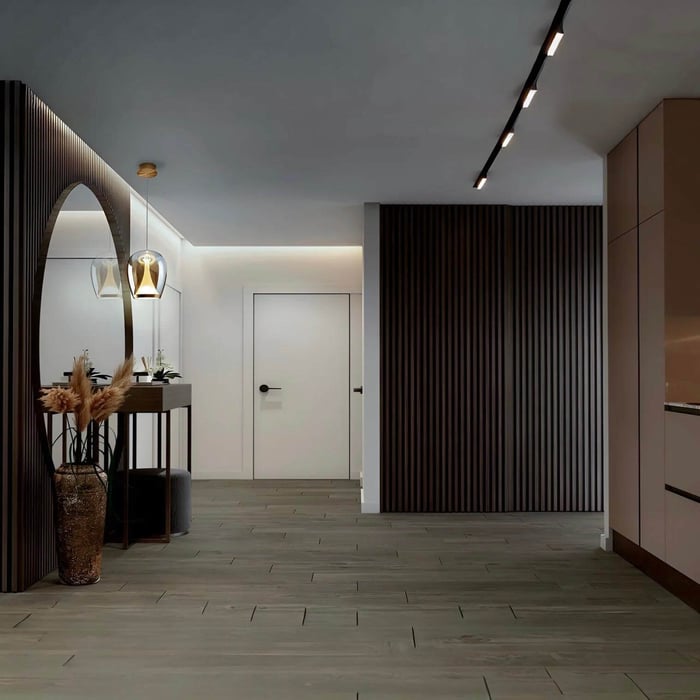 Modern entry hallway with vertical wood slat wall panels, a floating console table beneath an arched mirror, glass pendant lights, and a white interior door with recessed ceiling lighting.