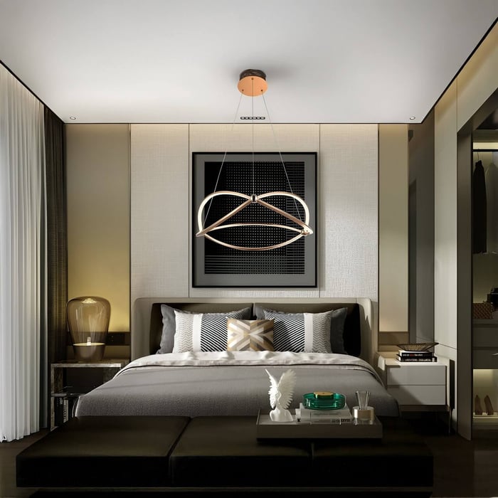 Modern bedroom with a geometric pendant light centered above the bed, surrounded by neutral-toned furnishings and accent lighting.