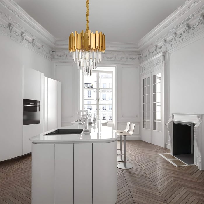 White Parisian-style kitchen with gold chandelier, detailed cornices, and central curved island.