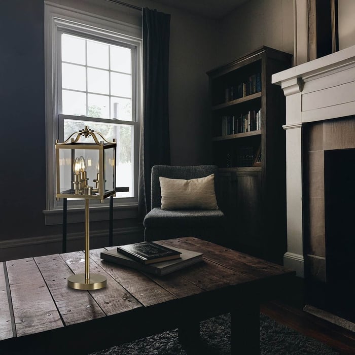 Cozy reading nook with a brass lantern-style table lamp on a rustic wooden coffee table.