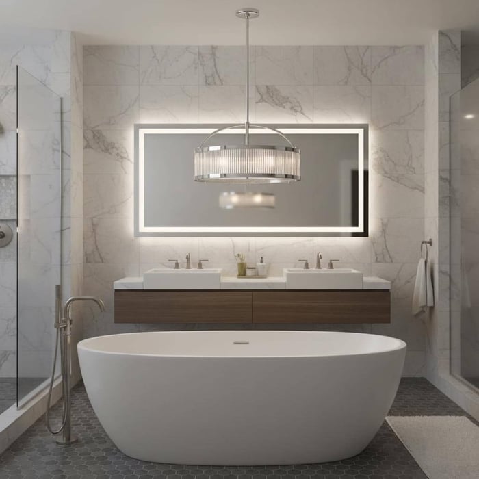 Luxury bathroom with a freestanding oval tub in front of a floating double vanity, large backlit mirror, and a drum-style pendant chandelier.