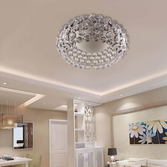Crystal flush-mount ceiling light with clear glass drops in a modern low-ceiling living room.