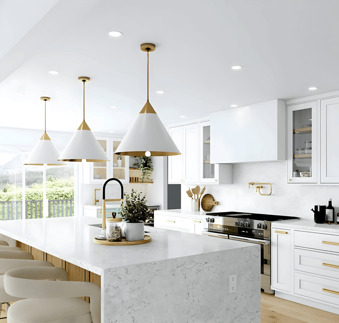  Bright white kitchen with gold and white cone pendant lights over a marble island and brushed brass accents.