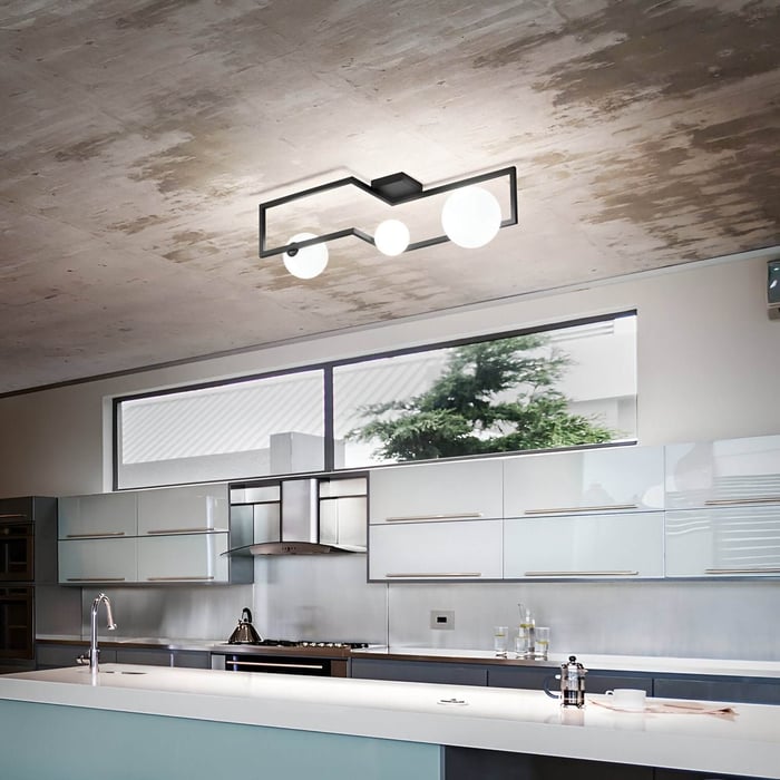Modern kitchen with concrete ceiling, frosted cabinetry, and geometric black ceiling fixture with globe bulbs