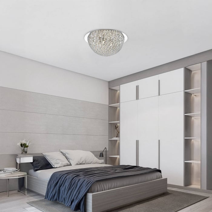 Modern bedroom with a teal bed frame, neutral bedding, built-in wall unit, and a small chandelier-style flush mount ceiling light.