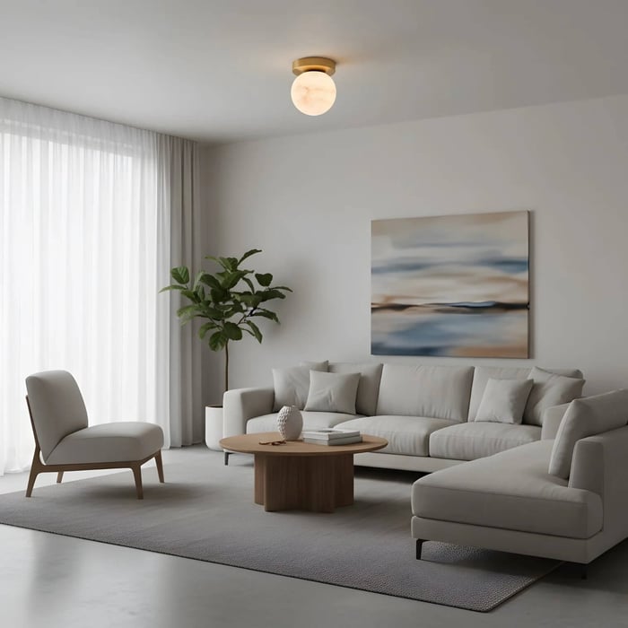 Light, airy living room with a small round ceiling globe light, neutral seating, sheer curtains, and abstract wall art above the sofa.