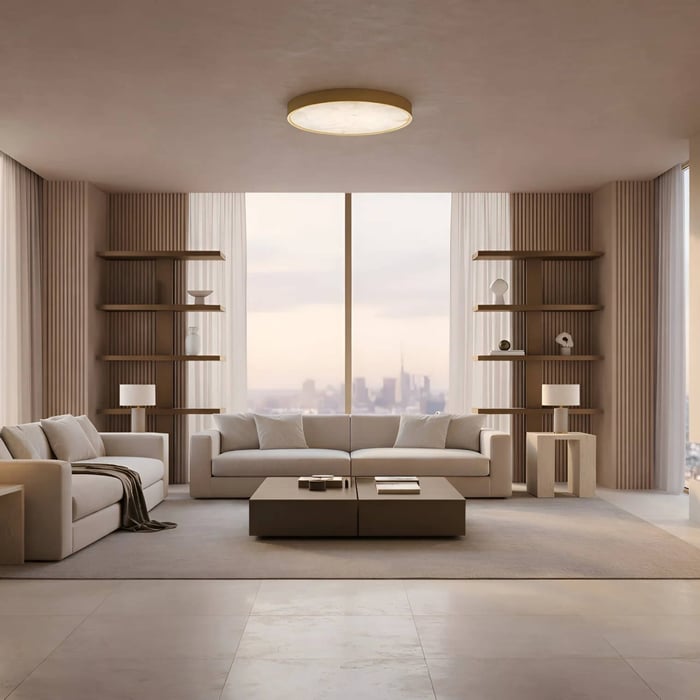 Minimalist living room with a circular flush ceiling fixture, symmetrical shelving, neutral sofas, and floor-to-ceiling windows with a soft cityscape backdrop.
