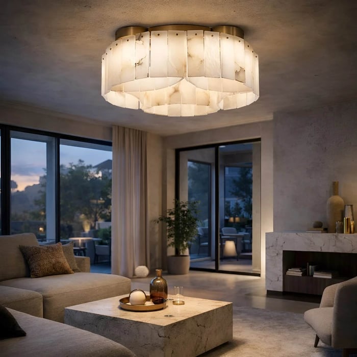 Contemporary living room featuring a tiered alabaster-style chandelier, marble fireplace, and large glass doors opening to an outdoor patio at dusk.