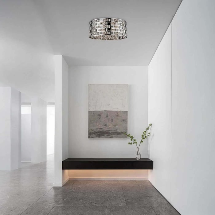 Minimal white hallway with a sparkling crystal flush ceiling light above a floating bench.