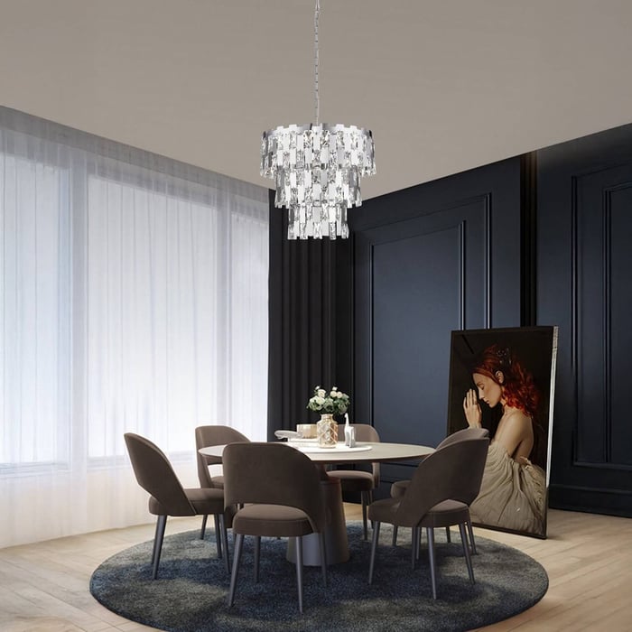 Tiered crystal chandelier with rectangular prisms hangs above a round dining table in a dark-paneled contemporary room.