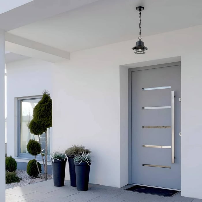 Modern white porch entry with a small black hanging pendant light above the front door.