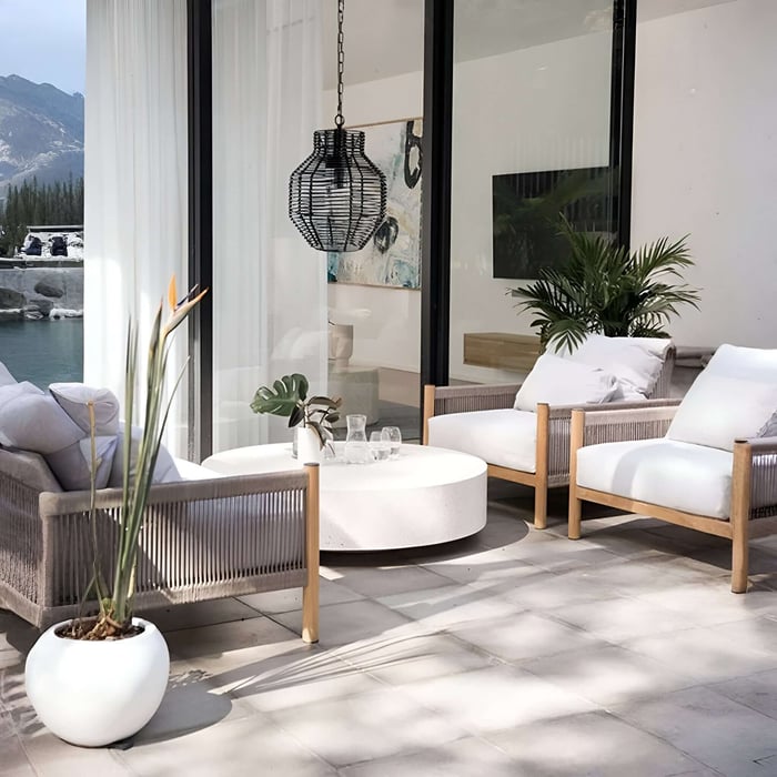Contemporary patio seating area with a black woven hanging pendant light near sliding glass doors.