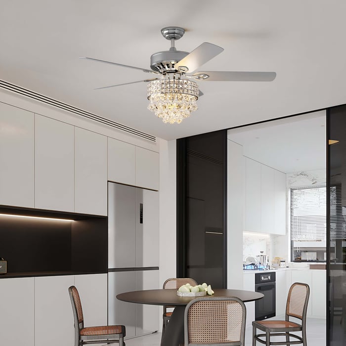 Crystal chandelier ceiling fan with sleek silver blades in a modern dining space.