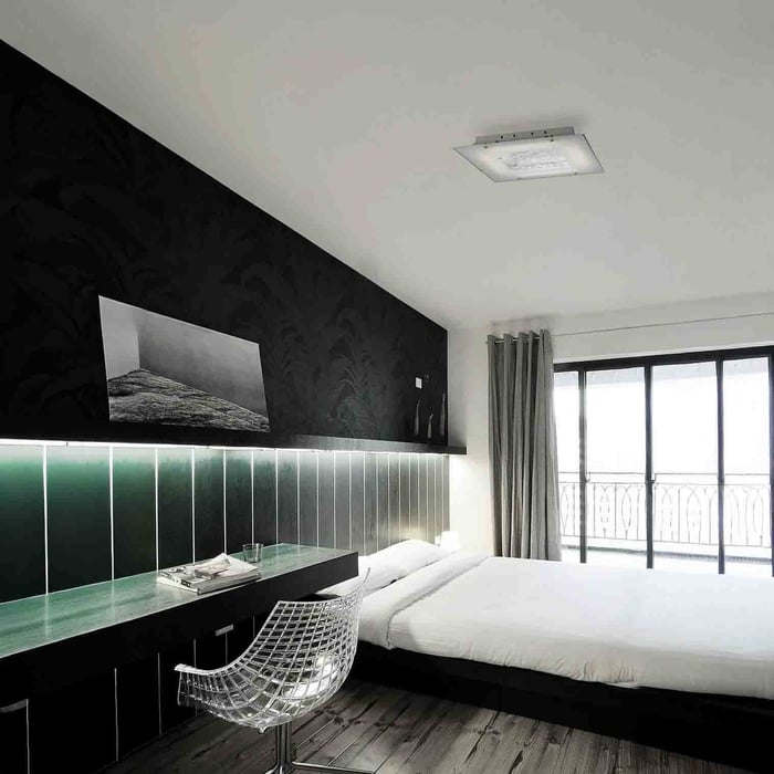 Modern bedroom with built-in desk, LED headboard lighting, and flush ceiling light.