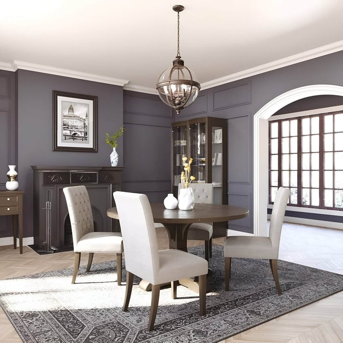 Globe-style chandelier with intersecting metal bands hangs above a classic dining room table in a grey-paneled interior.