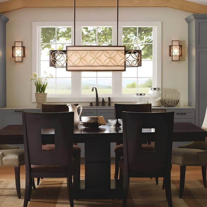 Transitional dining room with rectangular pendant lighting and matching wall sconces above a dark wooden dining table.