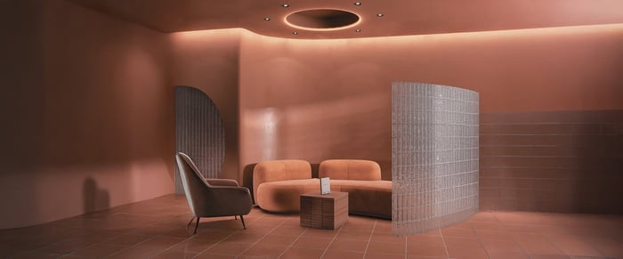 A modern lounge area with recessed ceiling lights and an ambient circular light feature, creating a warm, cozy atmosphere.